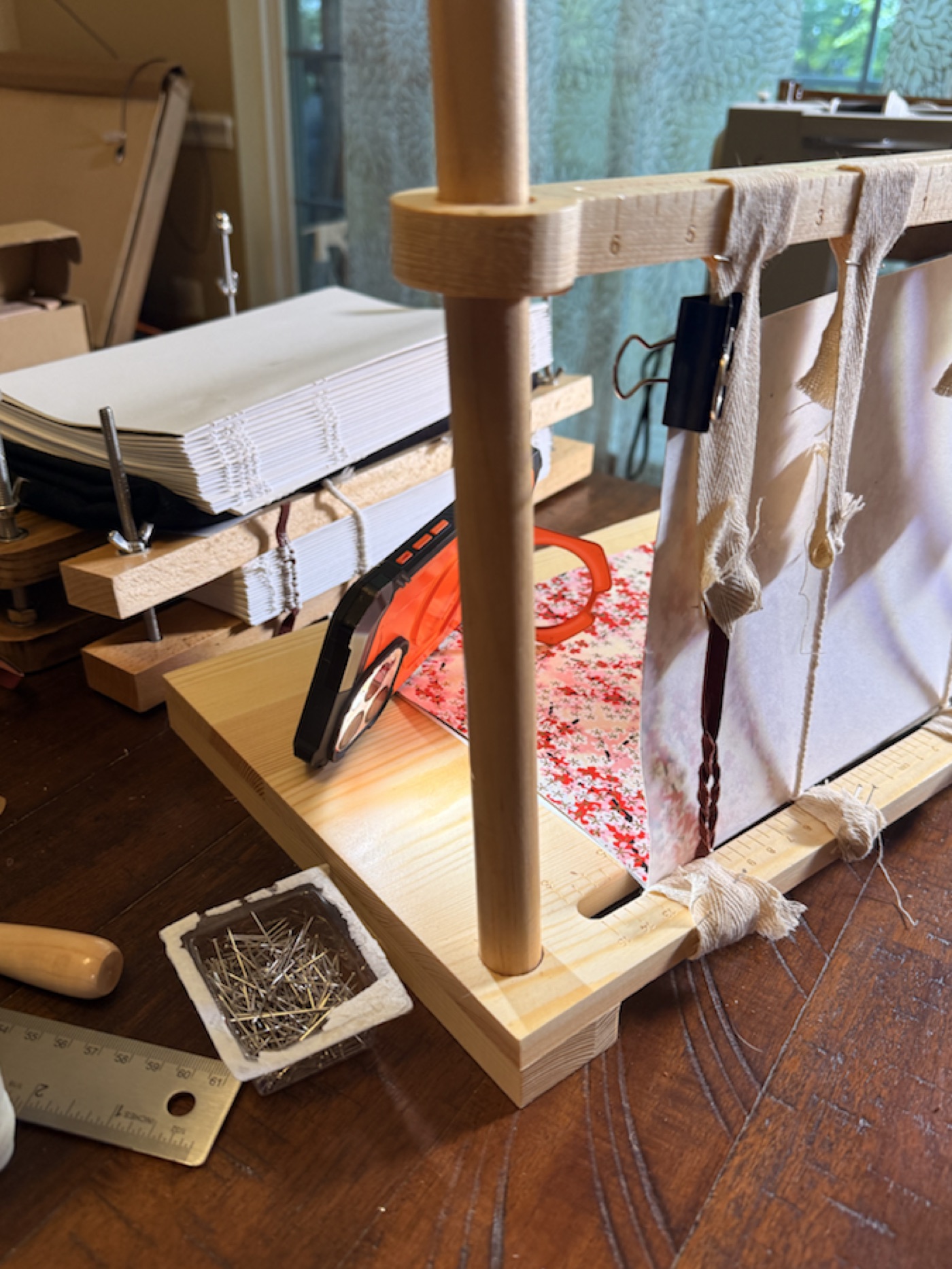Sewn signatures secured on a traditional bookbinding frame