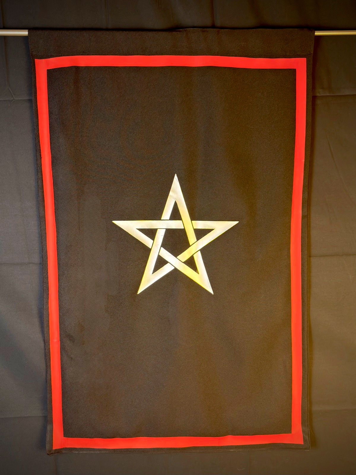 Martinist Associate Banner for Russian Martinism — dark field, red border, and gold-and-silver interlaced star, hanging from a rod.